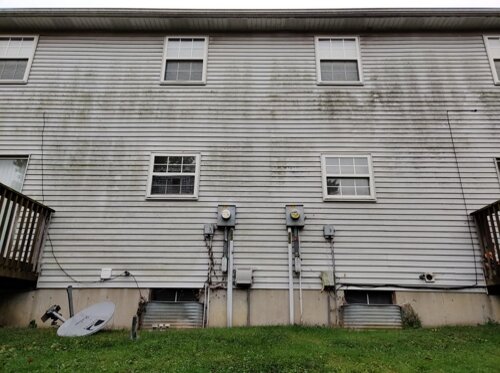 Home siding before pressure washing