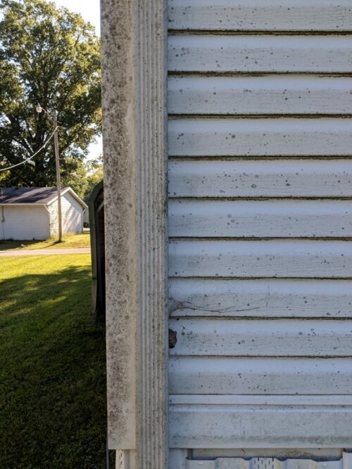 Home siding before pressure washing