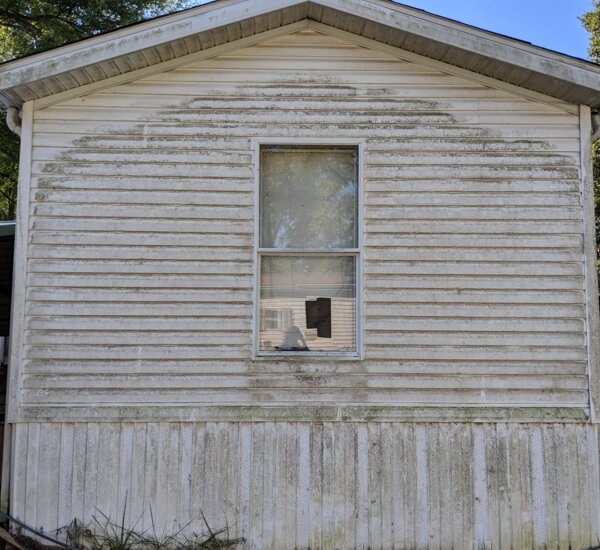 Home siding before pressure washing